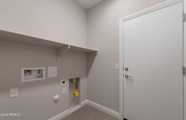 clothes washing area with laundry area, baseboards, gas dryer hookup, hookup for a washing machine, and electric dryer hookup