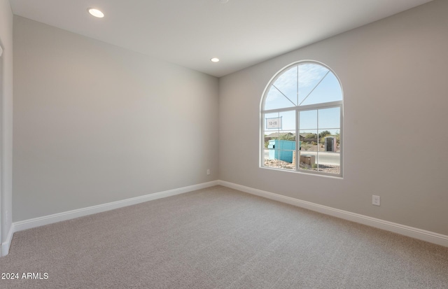 unfurnished room featuring light carpet, recessed lighting, and baseboards