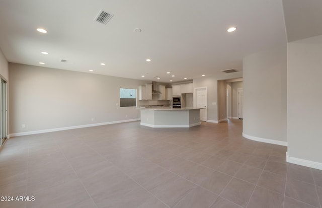 unfurnished living room with baseboards, visible vents, and recessed lighting