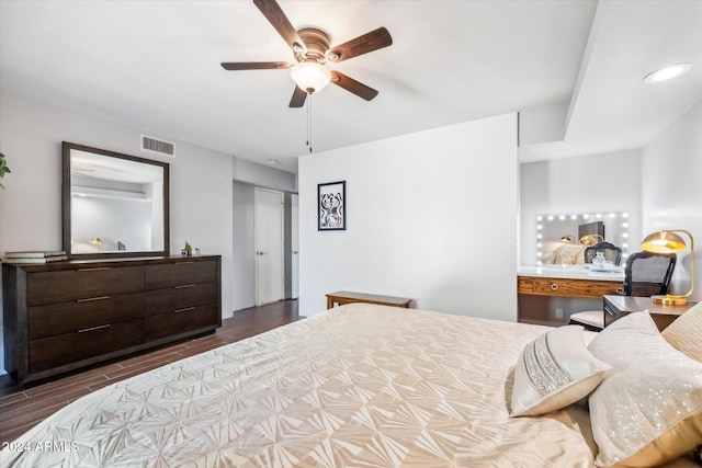 bedroom featuring ceiling fan, dark wood-type flooring, and a closet