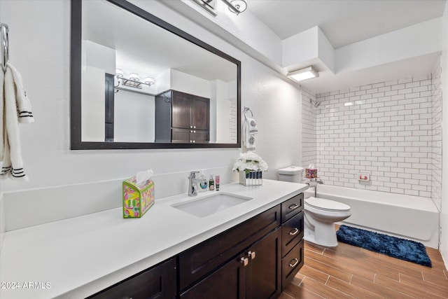 full bathroom featuring toilet, hardwood / wood-style floors, vanity, and tiled shower / bath