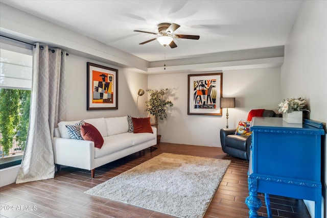 living room featuring dark hardwood / wood-style floors and ceiling fan