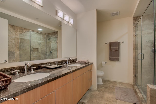 bathroom with vanity, toilet, and walk in shower