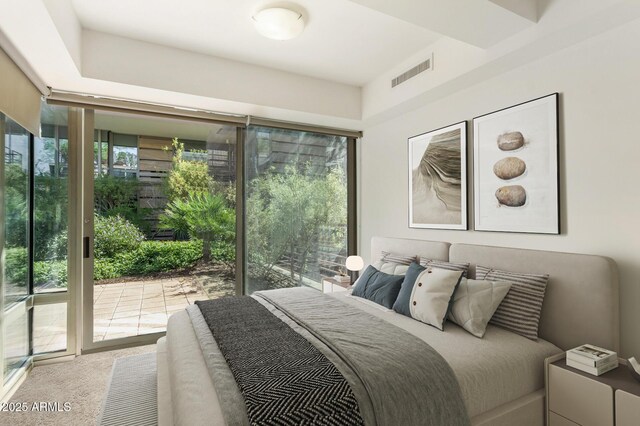 carpeted bedroom with access to exterior and visible vents