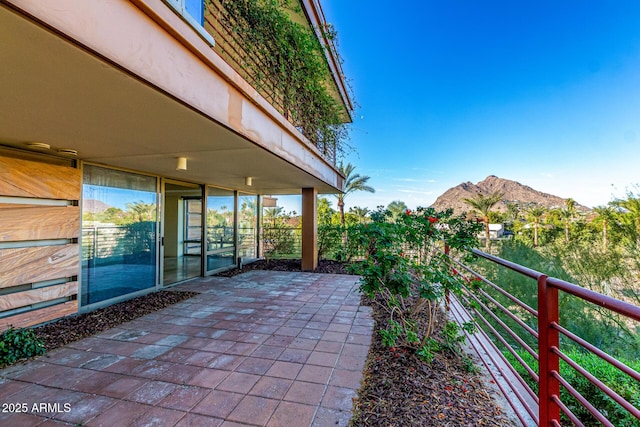 view of patio / terrace with a balcony and a mountain view