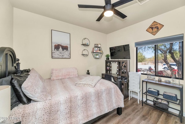 bedroom with ceiling fan and wood finished floors