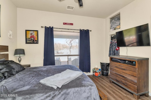 bedroom featuring visible vents and wood finished floors