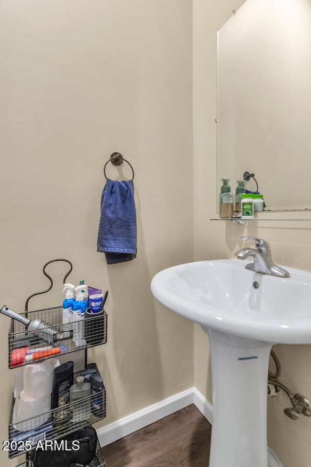 bathroom featuring baseboards and wood finished floors