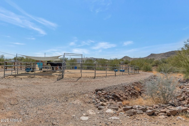 view of jungle gym with an exterior structure, an outdoor structure, and a mountain view