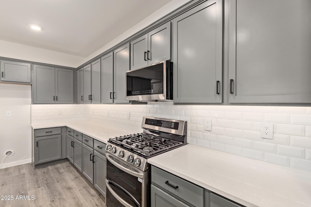 kitchen with stainless steel appliances and gray cabinetry