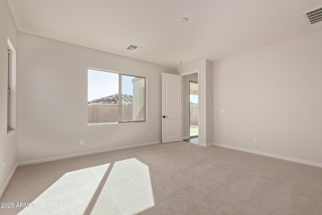 empty room with light colored carpet