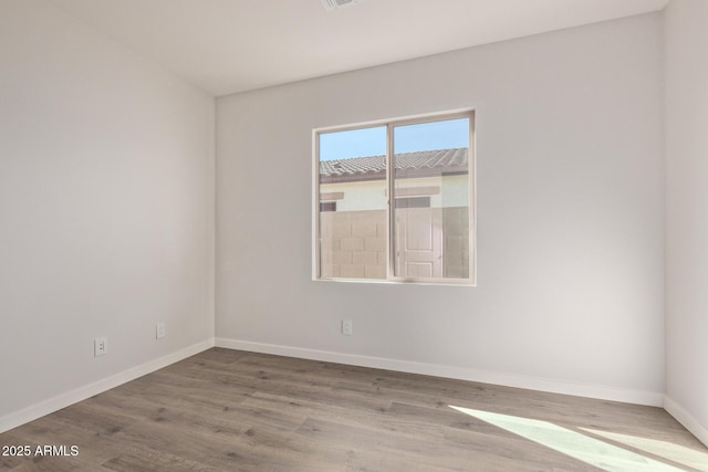 unfurnished room featuring hardwood / wood-style flooring