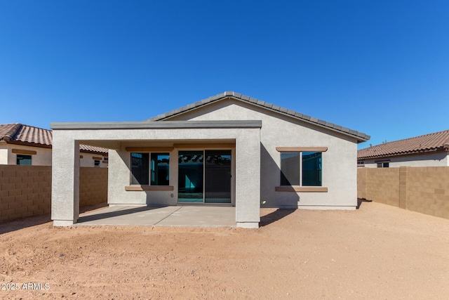 rear view of property featuring a patio area