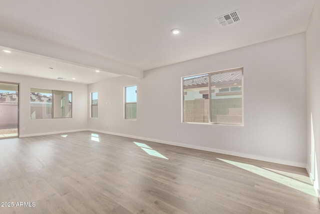 empty room with basketball hoop, light hardwood / wood-style flooring, and beamed ceiling