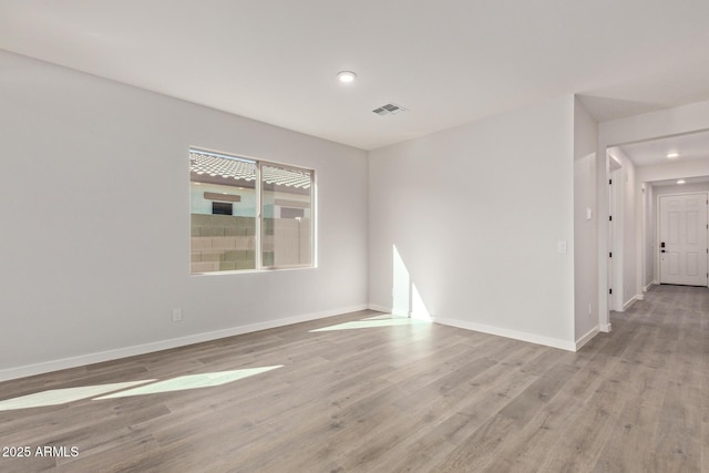 unfurnished room with light hardwood / wood-style floors