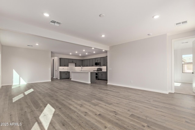 unfurnished living room featuring light hardwood / wood-style flooring