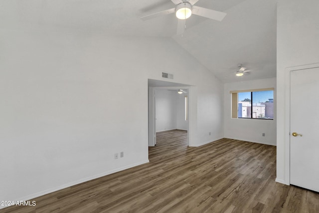 spare room with hardwood / wood-style floors, high vaulted ceiling, and ceiling fan