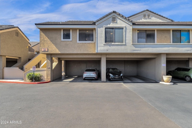 view of front of property with a garage and a carport