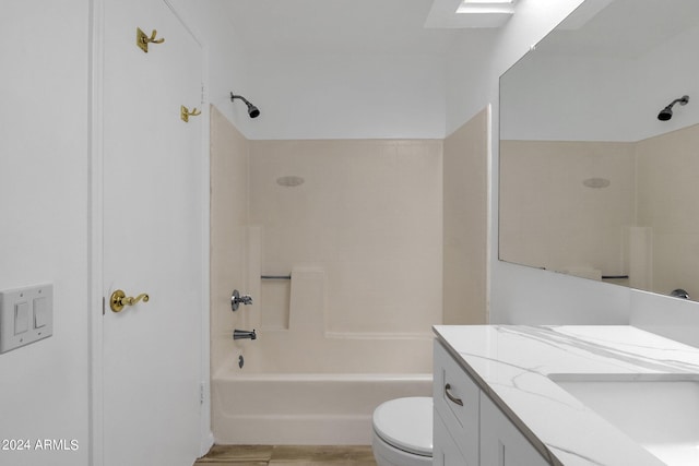 full bathroom featuring toilet, tiled shower / bath, and vanity