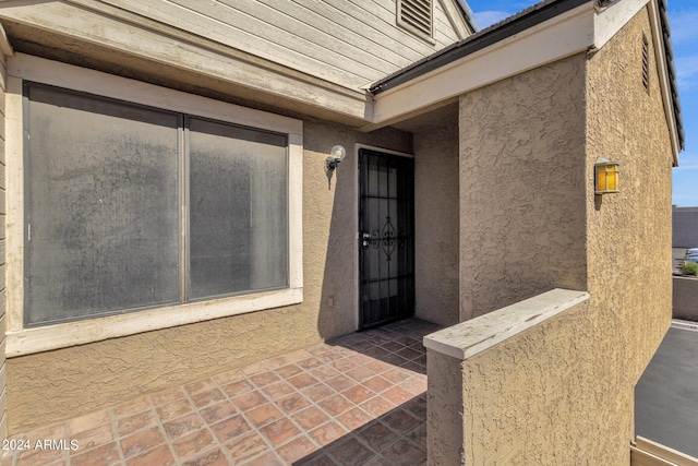 doorway to property with a patio area