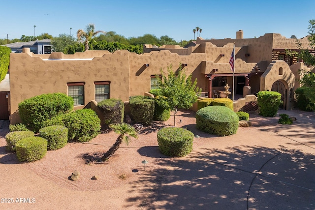 southwest-style home featuring stucco siding