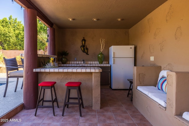 view of patio with outdoor dry bar