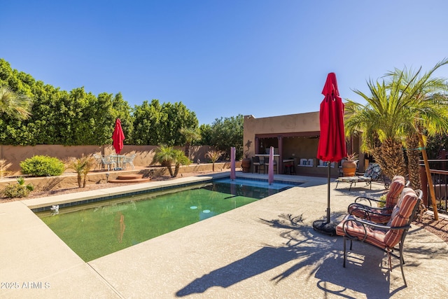 view of swimming pool featuring a fenced in pool, a patio area, and fence
