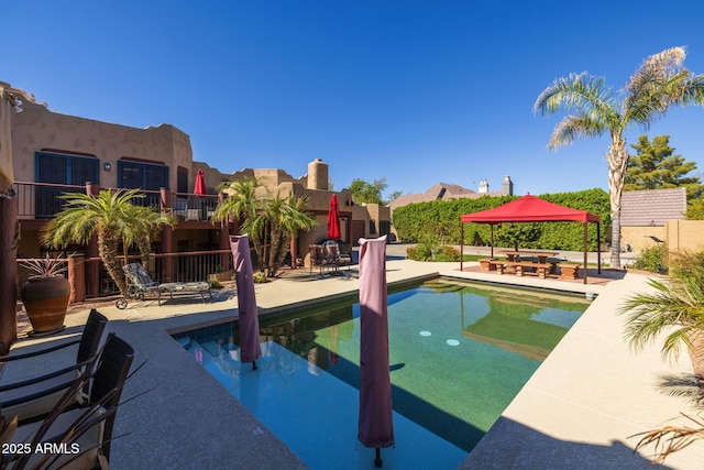 view of swimming pool featuring a fenced in pool, a patio area, and fence