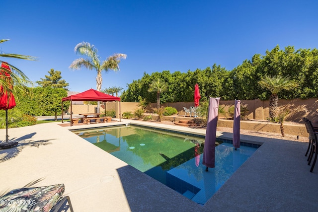 view of pool featuring a fenced in pool, a gazebo, a fenced backyard, and a patio area
