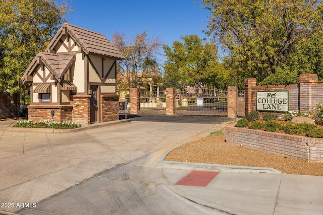 view of home's community with fence and a gate