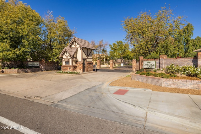 exterior space featuring fence and brick siding
