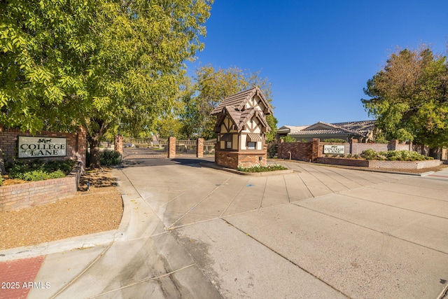 view of front of property featuring brick siding, a gate, and fence