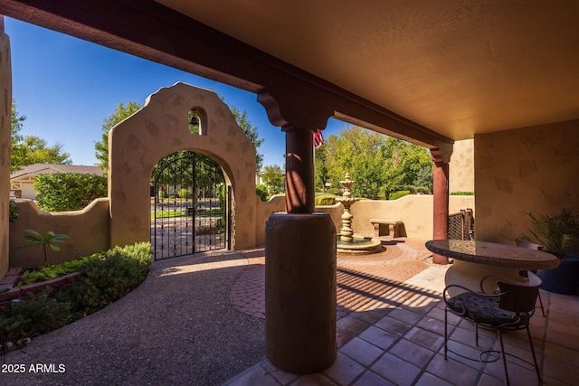 view of patio / terrace featuring fence and a gate