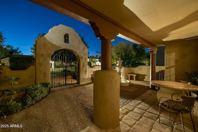 view of patio featuring fence and a gate