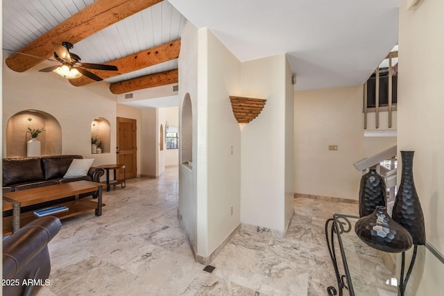 living area with wood ceiling, a ceiling fan, visible vents, beam ceiling, and baseboards