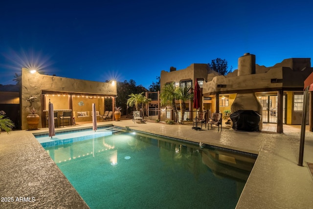 outdoor pool with a patio area