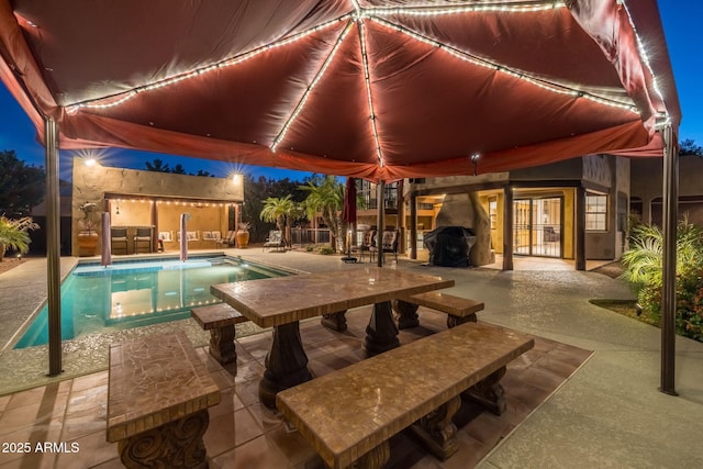 pool featuring a patio area and a grill