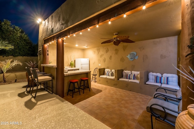 view of patio / terrace with fence, a ceiling fan, and outdoor dry bar