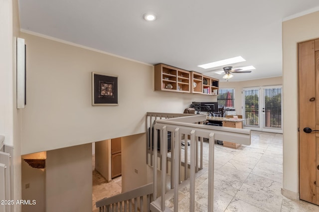 interior space featuring crown molding and a skylight