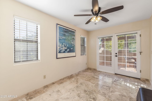 unfurnished room featuring baseboards, ceiling fan, and french doors
