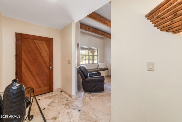 foyer entrance with baseboards and marble finish floor