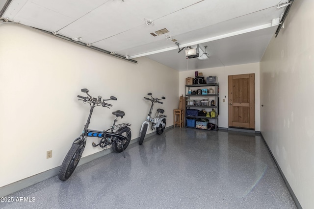 garage featuring baseboards and a garage door opener