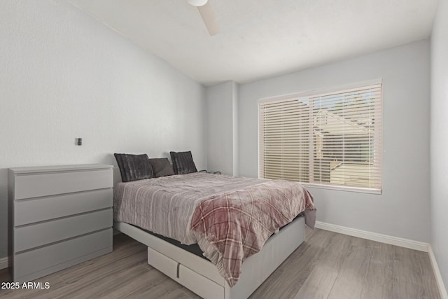 bedroom with wood finished floors and baseboards