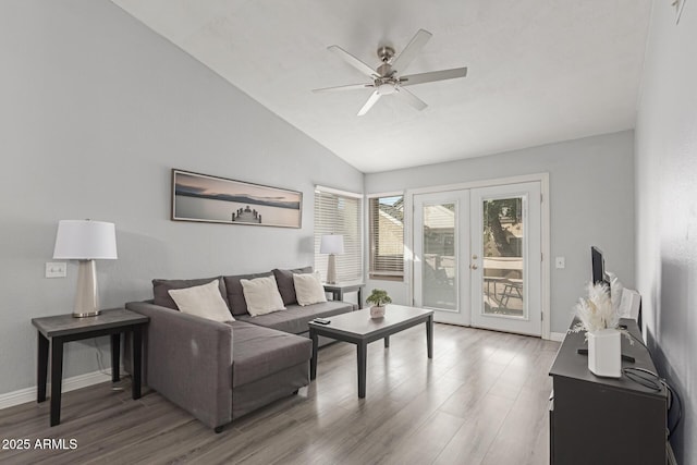 living area featuring vaulted ceiling, french doors, wood finished floors, and a ceiling fan