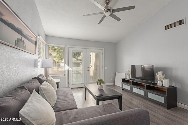 living room with baseboards, visible vents, ceiling fan, wood finished floors, and french doors