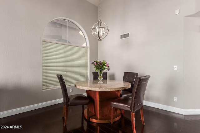 dining room featuring dark hardwood / wood-style floors and a notable chandelier