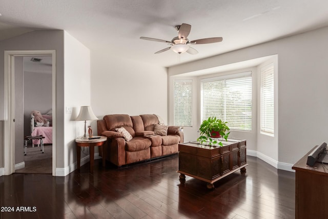 living room with ceiling fan and dark hardwood / wood-style flooring