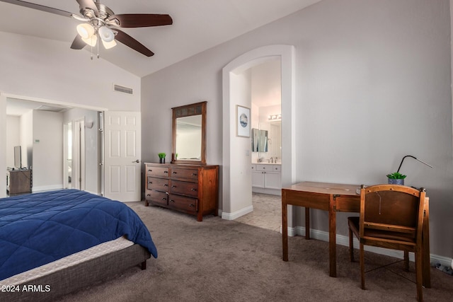 carpeted bedroom with ensuite bathroom, ceiling fan, and lofted ceiling