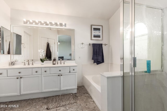 bathroom with vanity, ceiling fan, and plus walk in shower