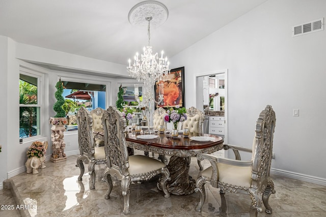 6941 W Voltaire Ave, Peoria, AZ 85381 - dining space with a chandelier, baseboards, and lofted ceiling